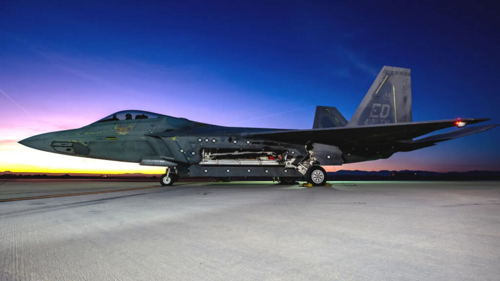 An F-22 Raptor and YFQ-44A Fury unmanned combat aircraft flying in formation over Edwards Air Force Base
